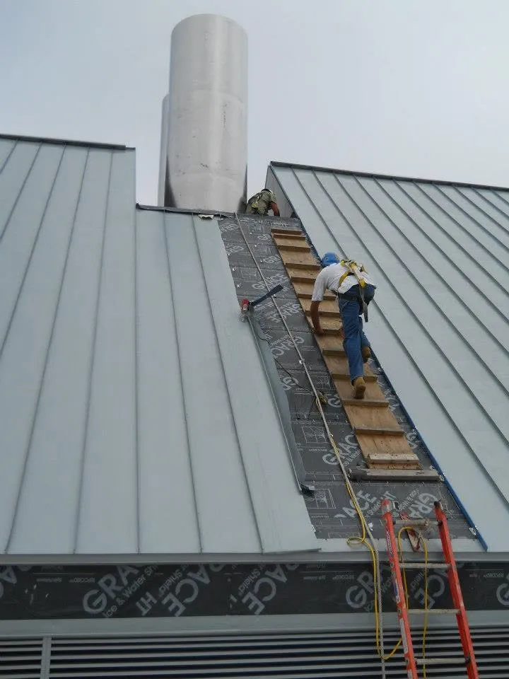 Roofing workers installing metal roof panels in La Mesa CA – expert new construction and re-roofing installation services
